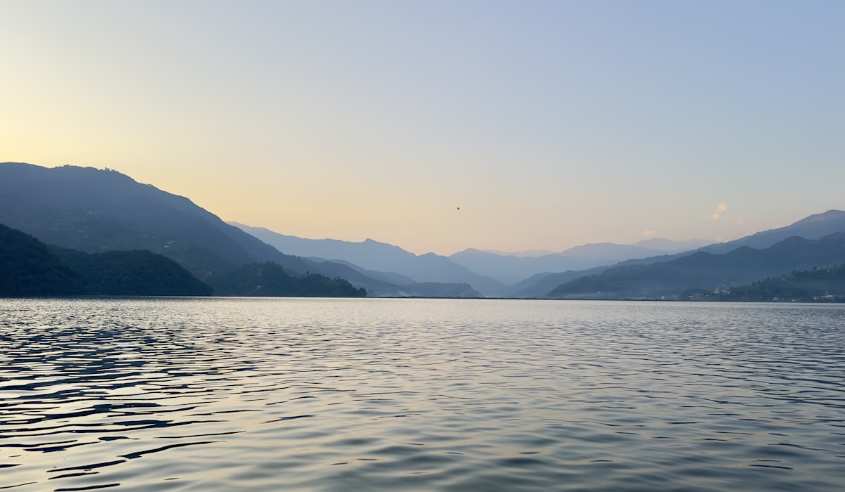 Dawn over Phewa Lake in Pokhara, where the Panchase trek begins with a boat crossing